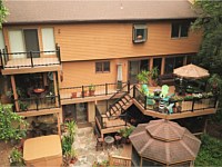 <b>Multi-level TimberTech Reserve Antique Leather composite decking with black Ultralox aluminum railing with glass picket infills</b>